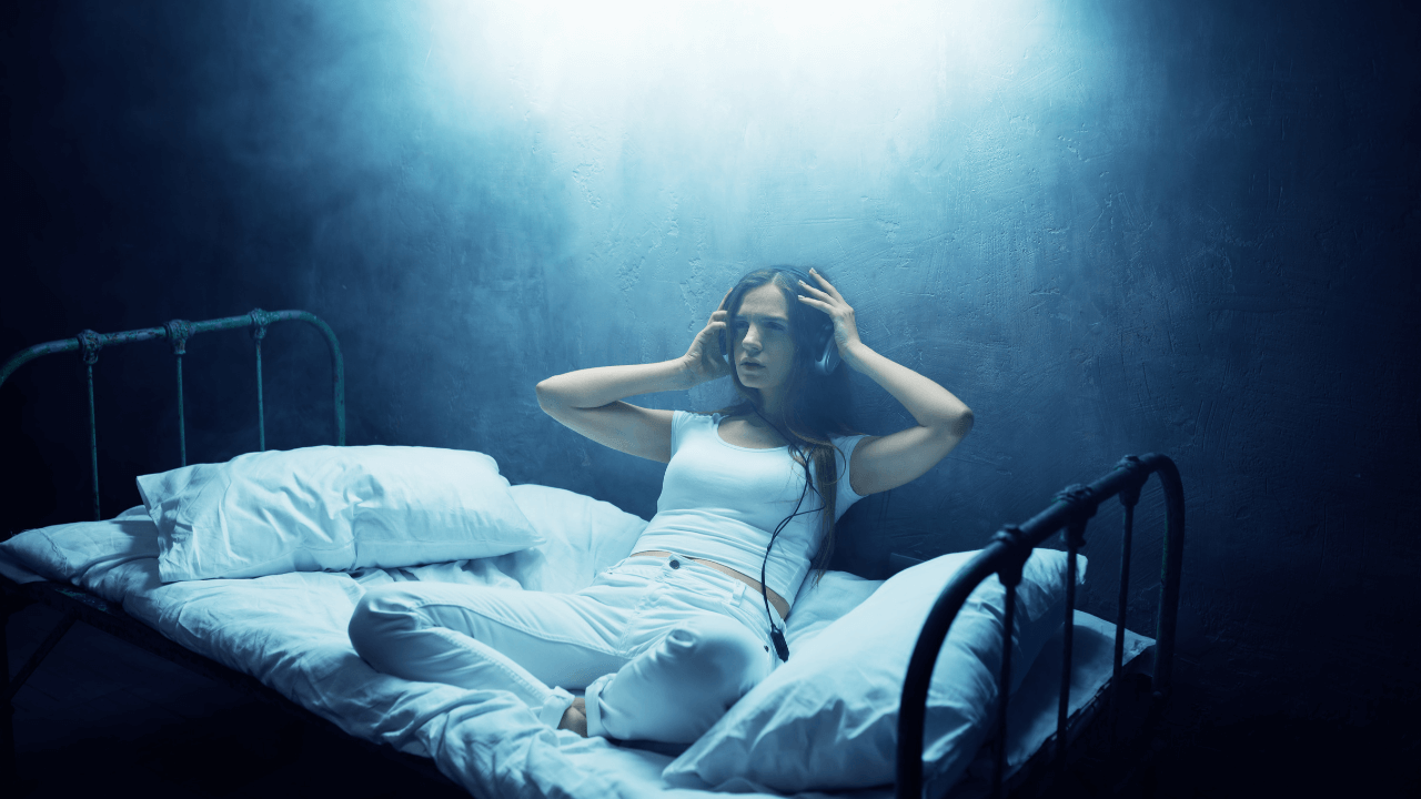 Girl with a headset listening to audio porn on here bed at night