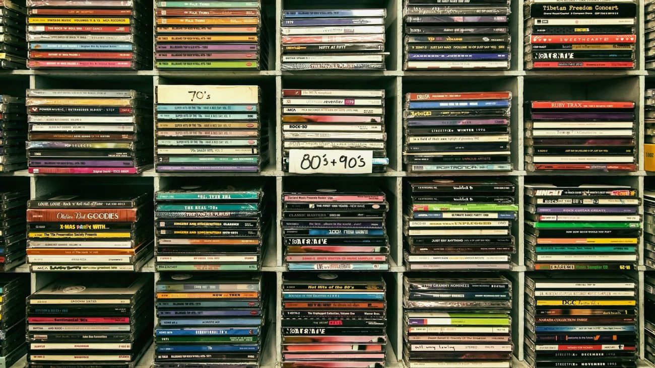 A wall filled with music cds from different decades